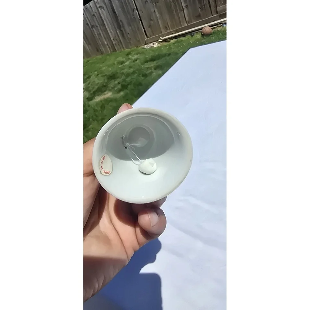 vintage/collectible porcelain souvenir bell featuring a map graphic of Colorado